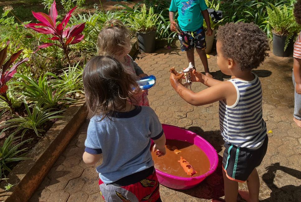 Children playing together with water in the garden